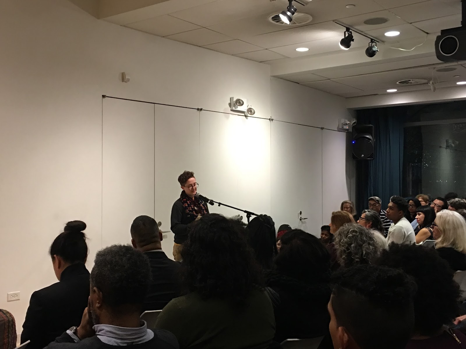 Poet reading to a crowd at Poet's House in New York